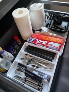 a drawer in a refrigerator filled with utensils at Hope Private Villa tateyama in Tateyama +13 photos