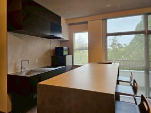 a kitchen with a counter and a large window at Hope Private Villa tateyama in Tateyama