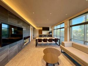 a living room with a table and a dining room at Hope Private Villa tateyama in Tateyama
