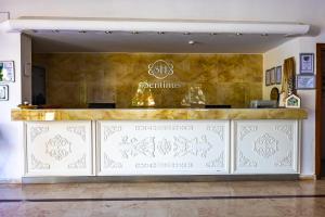 a restaurant with a counter with a sign on it at Sentinus Beach Hotel in Kuşadası +36 photos