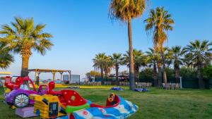 a park with a playground with a toy train at Sentinus Beach Hotel in Kuşadası