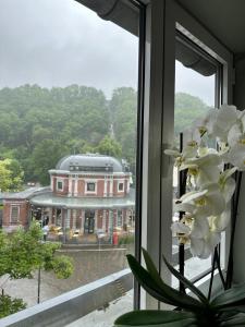 a window with a view of a building at Lola des Sources in Spa
