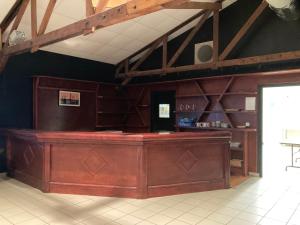 a bar in a room with a ceiling with beams at Chambres à 2 pas du Mans in Trangé