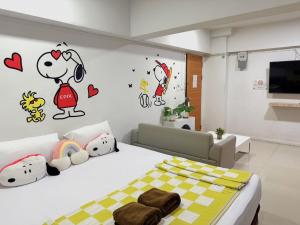 a bedroom with a bed with hello kitty stickers on the wall at 48 Ville Donmuang Airport in Bangkok