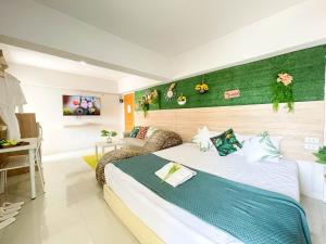 a hotel room with a bed and a couch at 48 Ville Donmuang Airport in Bangkok