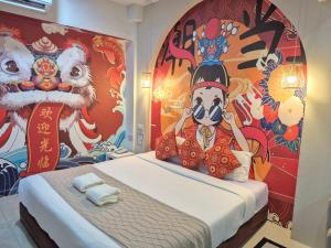 a room with a bed with a painting on the wall at 48 Ville Donmuang Airport in Bangkok