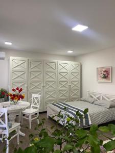 a bedroom with a bed and a table and chairs at La casa di Elena in Reni