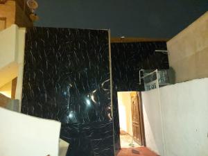 a room with a wall covered in black marble at Sneferu hotel pyramids View in Cairo +1 photo