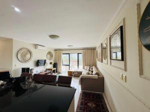 a large living room with a couch and chairs at Manhattan Escape Suite By Ezey Tours in Cape Town