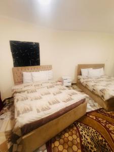 two beds sitting next to each other in a room at Sneferu hotel pyramids View in Cairo
