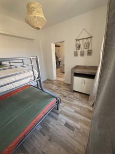 a bedroom with a bunk bed and a desk at la petite colline in Cavaillon