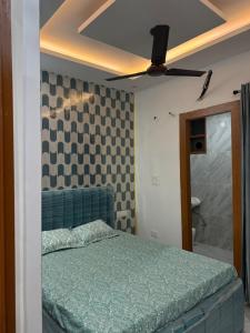 a bedroom with a bed and a ceiling fan at Aanya Bnb in Zirakpur