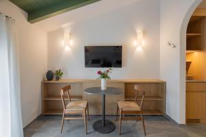 a dining room with a table and two chairs at Vigne del Malina - Agriturismo & Winery in Orzano