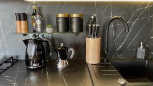 a kitchen counter with a coffee maker and a sink at Sunset Coast - Paradise Cottage in Drage