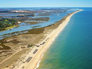 an aerial view of a beach and the ocean at Hotel Quinta do Lago in Quinta do Lago