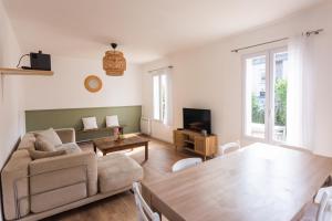 a living room with a couch and a table at Maison avec parking la Flocellière in La Flocellière