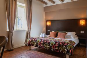 a bedroom with a large bed and a window at Le clos aux roses in Chédigny