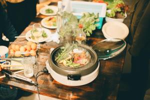 a table with food and plates of food on it at 民泊やまねこ in Yachi