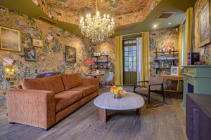 a living room with a couch and a table at Villa MONTGOMMERY in Saint-Jean-le-Thomas