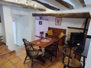 a dining room with a wooden table and chairs at The Retreat in Las Encebras