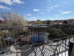 a patio with two chairs and a table on a balcony at ApartmentsByMatyrafa-XV in Tarnowskie Góry