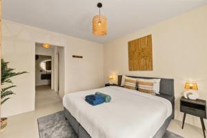 a bedroom with a large white bed in a room at Marina Apartment A2, luxury waterfront apartment Spanish Water, Jan Thiel, Curaçao in Jan Thiel