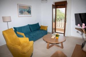 a living room with a blue couch and a table at Agnanti in Agia Fotini