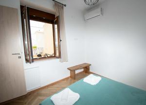 a room with a blue bed with a bench in it at Agnanti in Agia Fotini