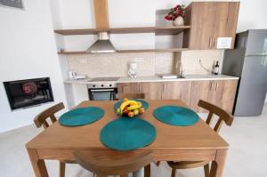 a kitchen with a wooden table with bananas on it at Agnanti in Agia Fotini +4 photos
