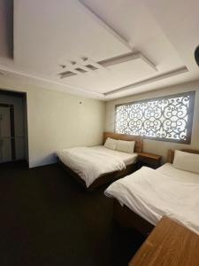 a room with two beds and a window at North Paradise Guest House in Skardu +6 photos