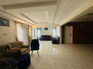 a lobby with couches and chairs in a building at North Paradise Guest House in Skardu