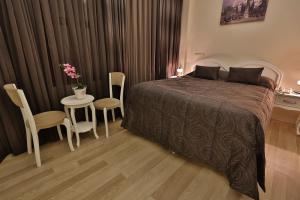 a bedroom with a bed and a table and chairs at Basilica Guest House in Istanbul