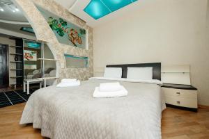 a bedroom with a large bed with two white pillows at ERA RENT Apartments in Chişinău +255 photos