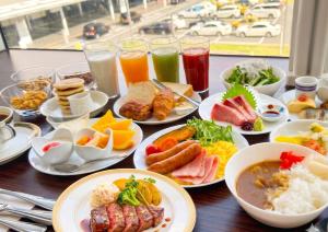 a table topped with plates of food and drinks at Hotel Clio Court Hakata in Fukuoka