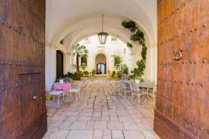an open hallway with tables and chairs in a building at Palazzo De Castro in Squinzano +130 photos