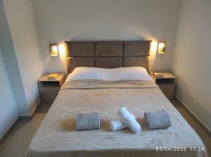 a bedroom with a bed with two towels on it at Calm Horizon Residence in Chios