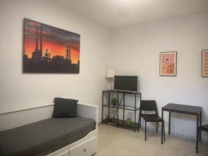 a bedroom with a bed and a table and a chair at Apartmán u Nové Karoliny in Slezská Ostrava
