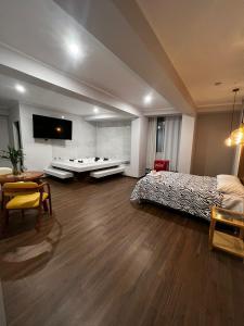 a large room with a bed and a table at Hotel Atenas in Barranco