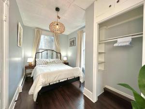 a bedroom with a bed and a chandelier at King Bed 2BR near the LaHave River and Trails in Bridgewater
