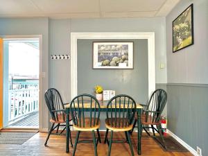 a dining room with a green table and chairs at King Bed 2BR near the LaHave River and Trails in Bridgewater