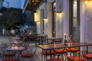 a row of tables and chairs in a restaurant at Airy Athens Suites in Athens