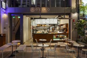 a restaurant with tables and chairs and a counter at Airy Athens Suites in Athens +16 photos
