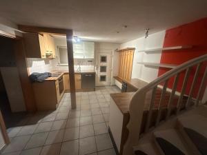 a small kitchen with a staircase leading to a room at Monteure Maisonette in Eggingen +10 photos