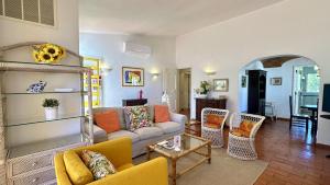a living room with a couch and chairs at Golfe - Shared Pool - 7 Pax - Vilamoura in Vilamoura