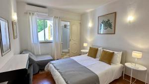 a bedroom with a bed and a desk and a piano at Golfe - Shared Pool - 7 Pax - Vilamoura in Vilamoura