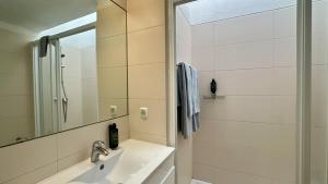 a bathroom with a sink and a mirror at Golfe - Shared Pool - 7 Pax - Vilamoura in Vilamoura +22 photos