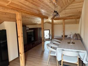 a kitchen and dining room with a table and chairs at Къща за гости Гергана in Troyan