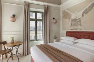 a bedroom with a large bed and a window at Airy Athens Suites in Athens
