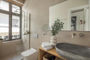 a bathroom with a large sink and a toilet at Airy Athens Suites in Athens