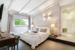 a bedroom with a bed and a desk and a window at Iblainsuite in Ragusa +60 photos